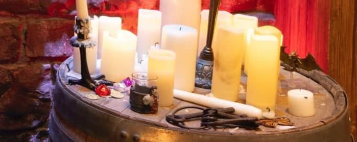 Bougies, chandelier et accessoires de jeu posés sur un tonneau